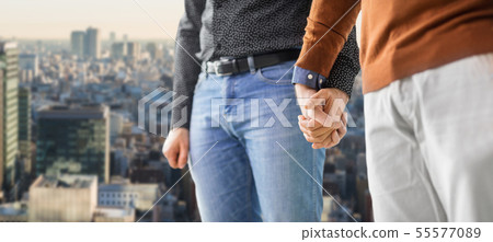 close up of male gay couple holding hands 55577089