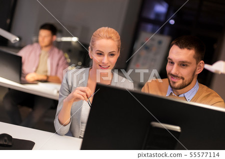 business team with computer working late at office 55577114