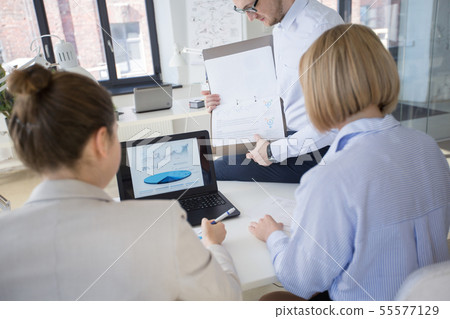 business team discussing charts at office business team discussing charts at office 55577129