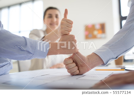 group of business team making thumbs up gesture group of business team making thumbs up gesture 55577134