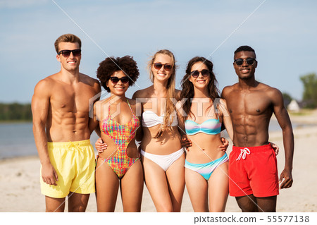 happy friends hugging on summer beach happy friends hugging on summer beach 55577138