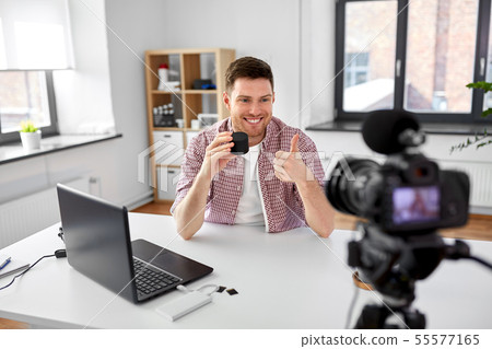 video blogger with smart speaker shows thumbs up video blogger with smart speaker shows thumbs up 55577165