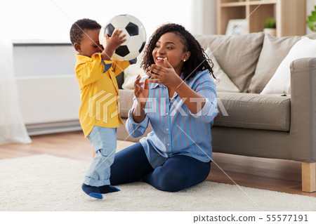 mother and baby playing with soccer ball at home mother and baby playing with soccer ball at home 55577191