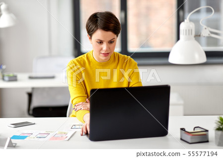 ui designer with laptop working at office 55577194