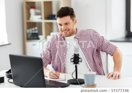 audio blogger with laptop, microphone and notebook 55577196