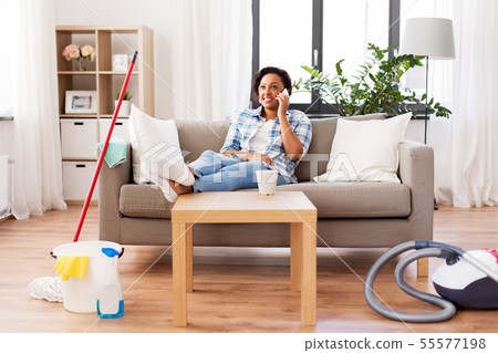 woman calling on smartphone after home cleaning woman calling on smartphone after home cleaning 55577198