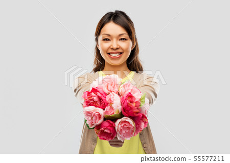 happy asian woman with bunch of flowers happy asian woman with bunch of flowers 55577211