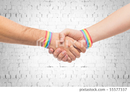 hands with gay pride wristbands make handshake hands with gay pride wristbands make handshake 55577337