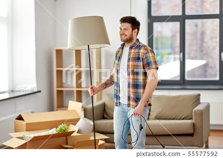 happy man with floor lamp moving to new home happy man with floor lamp moving to new home 55577592