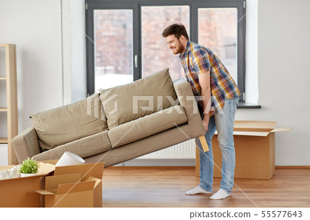happy man moving sofa at new home happy man moving sofa at new home 55577643