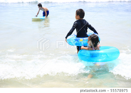 Swimming in the beach with family 55578975