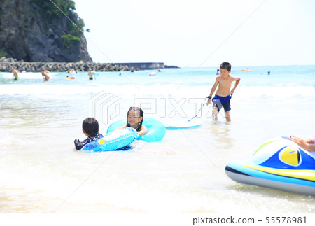 Swimming in the beach with family 55578981