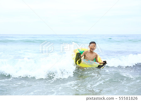 Boy surfing 55581826
