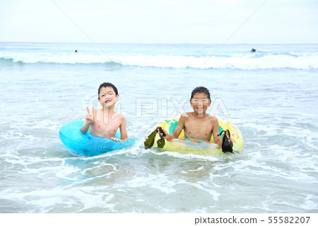 Boys playing on the beach 55582207