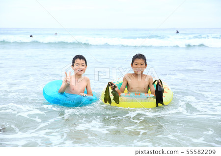 Boys playing on the beach 55582209