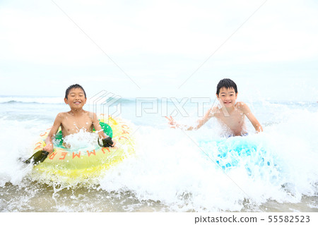 Boys playing on the beach 55582523