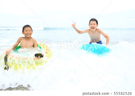 Boys playing on the beach 55582526