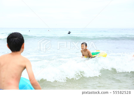 Boys playing on the beach 55582528