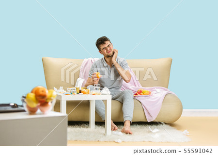 Young man suffering from allergy to citrus fruits 55591042