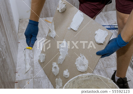 Tiler and plaster repair work laying tile, trowel 55592123