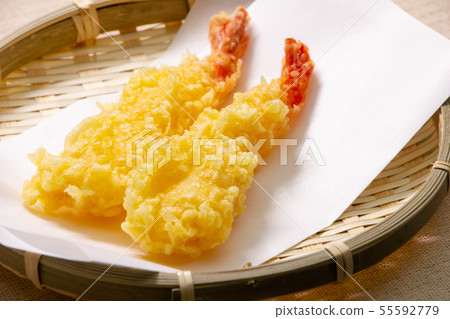 Two shrimp tempura. (Fried straight and served on a tempura laid paper.) Two shrimp tempura. (Fried straight and served on a tempura laid paper.) 55592779