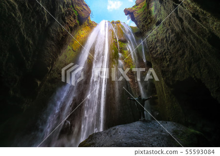 Traveler stunned by Gljufrabui waterfall cascade 55593084