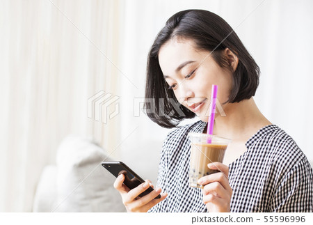 Smartphone, tapioca drink and female image material Smartphone, tapioca drink and female image material 55596996