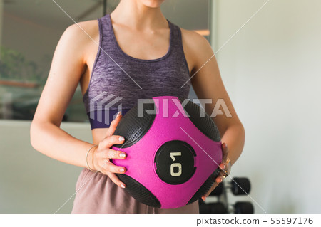 Young girl does an exercise with med ball 55597176