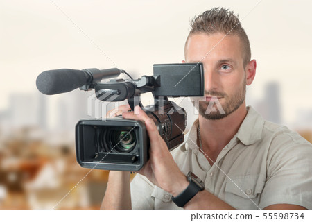 handsome cameraman with professional camcorder 55598734