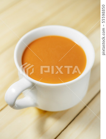 Hot milk tea in a white cup on wooden 55598850