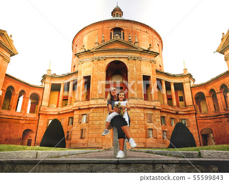 happy family in italy mother and daughter at the San Luca sanctuary church of Bologna in Emilia 55599843