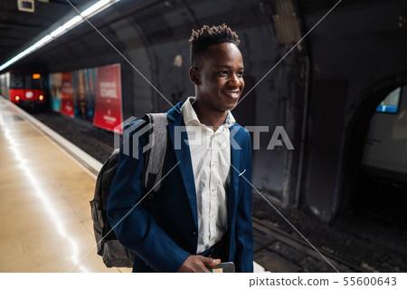 African American businessman wearing blue suit and backpack African American businessman wearing blue suit and backpack 55600643