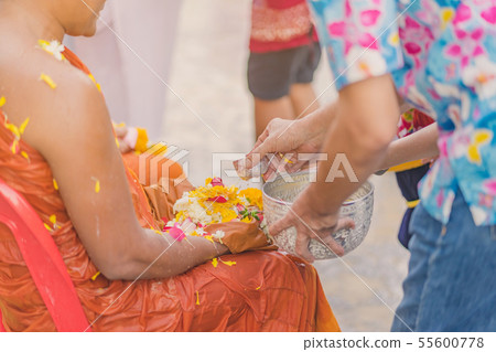 People pouring water to Buddhist Monk People pouring water to Buddhist Monk 55600778