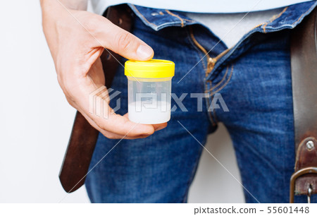 Man Holding in Hands Container With Sperm Man Holding in Hands Container With Sperm 55601448