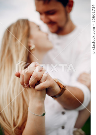 Beautiful couple spend time on a summer field 55601734