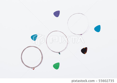 Flat lay steel guitar strings and plastic picks Flat lay steel guitar strings and plastic picks 55602735