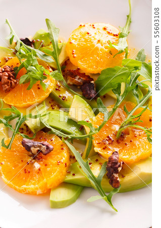 fresh avocado and orange salad on a beige plate 55603108