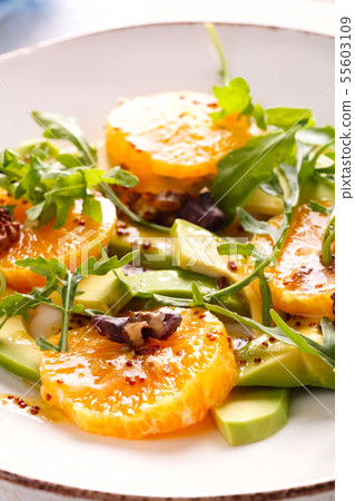 fresh avocado and orange salad on a beige plate fresh avocado and orange salad on a beige plate 55603109