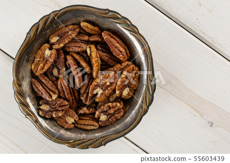 Fresh pecan nut on grey wood Fresh pecan nut on grey wood 55603439