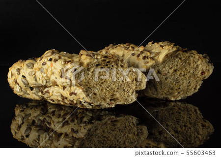 Fresh cereal baguette isolated on black glass Fresh cereal baguette isolated on black glass 55603463