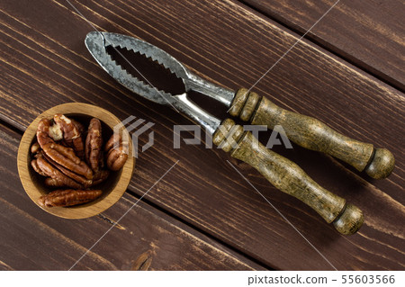 Fresh pecan nut on brown wood 55603566