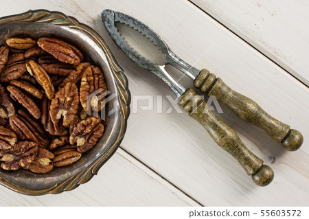 Fresh pecan nut on grey wood Fresh pecan nut on grey wood 55603572