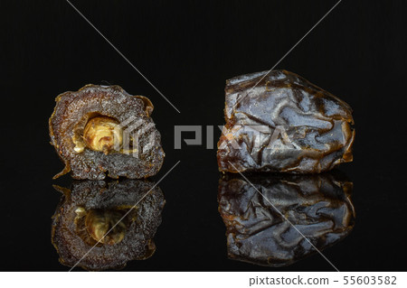 Dried date medjool isolated on black glass 55603582