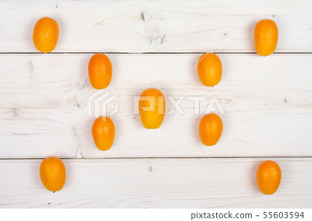 Fresh orange kumquat on grey wood Fresh orange kumquat on grey wood 55603594
