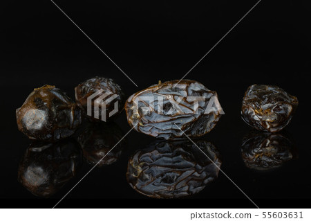 Dried date medjool isolated on black glass 55603631