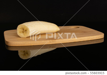 Ripe yellow banana isolated on black glass Ripe yellow banana isolated on black glass 55603915
