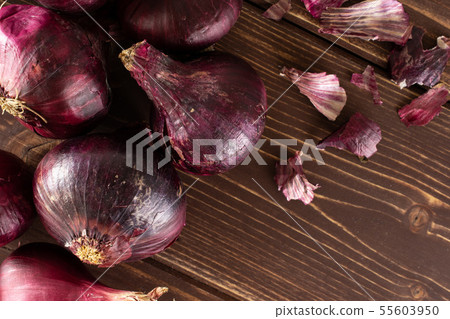 Stale red onion on brown wood Stale red onion on brown wood 55603950