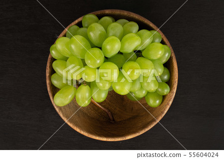 Fresh green grape on grey stone Fresh green grape on grey stone 55604024