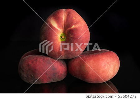 Fresh paraguay peach isolated on black glass Fresh paraguay peach isolated on black glass 55604272