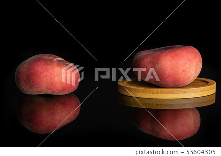Fresh paraguay peach isolated on black glass Fresh paraguay peach isolated on black glass 55604305